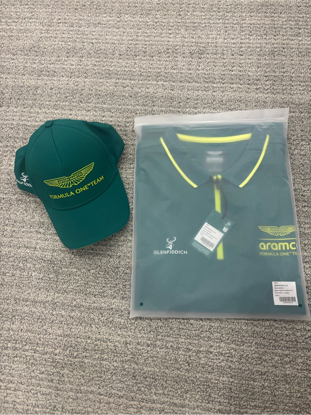 Aston Martin Aramco F1 Polo with matching cap. 2 items.